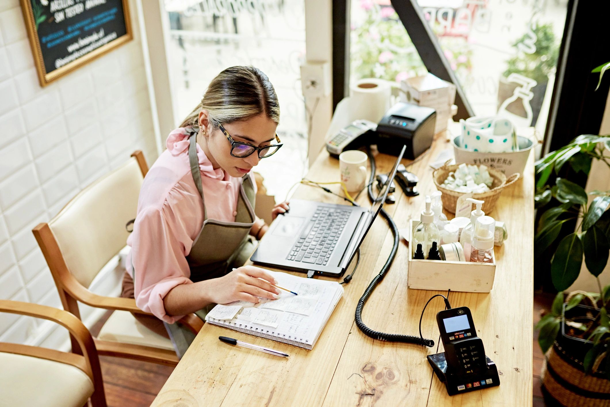 Small business owner using a laptop in a retail shop
