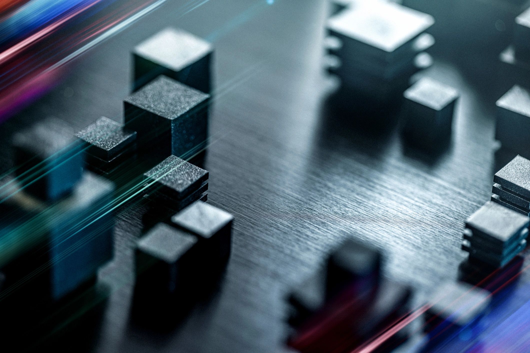 Metallic blocks on a sleek circuit-like surface, illuminated by vibrant neon streaks and glows. This image conveys technology, precision, and modern design, suitable for tech branding, engineering, and digital innovation themes.